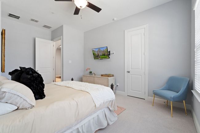 Bedroom with light carpet and a ceiling fan | Image 17
