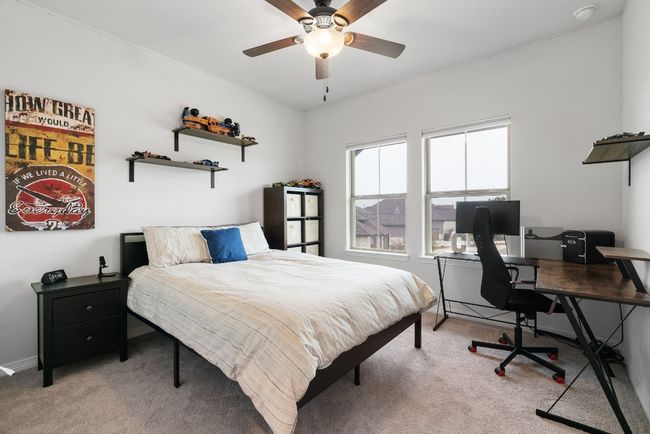 Another nice-sized bedroom with a ceiling fan and carpet flooring throughout. | Image 29