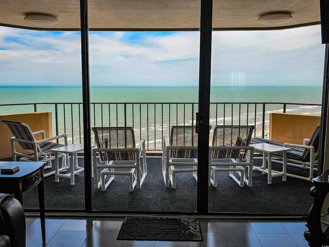 Balcony featuring view of water and beach | Image 10