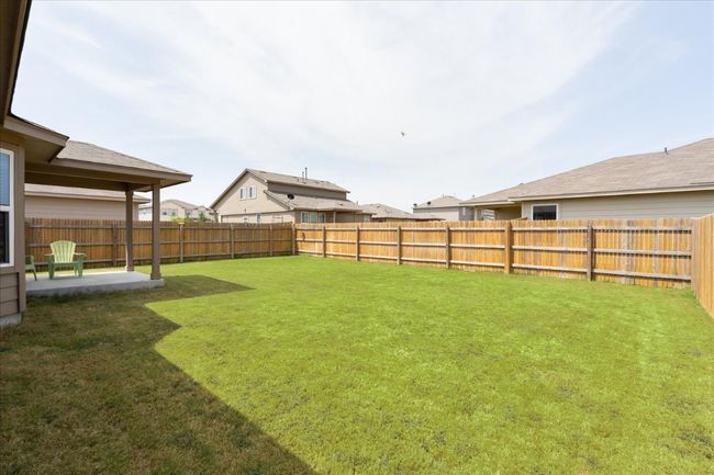 View of yard with a fenced backyard and a patio | Image 28