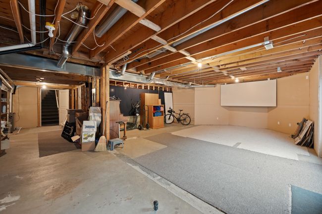 Unfinished basement featuring stairs | Image 34