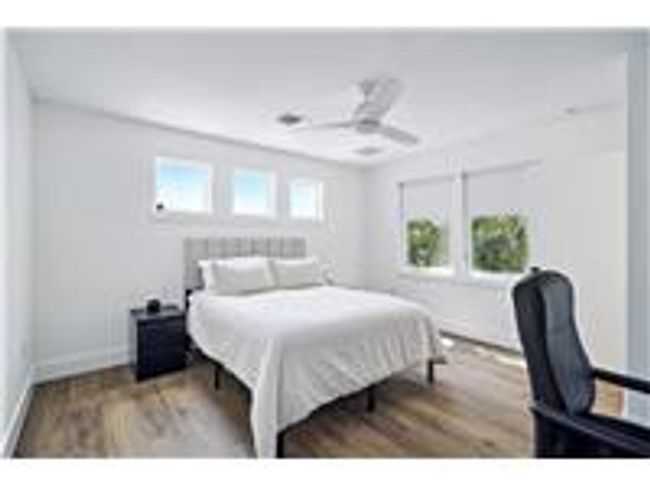 2nd floor bedroom with wood finished floors, and ceiling fan | Image 19