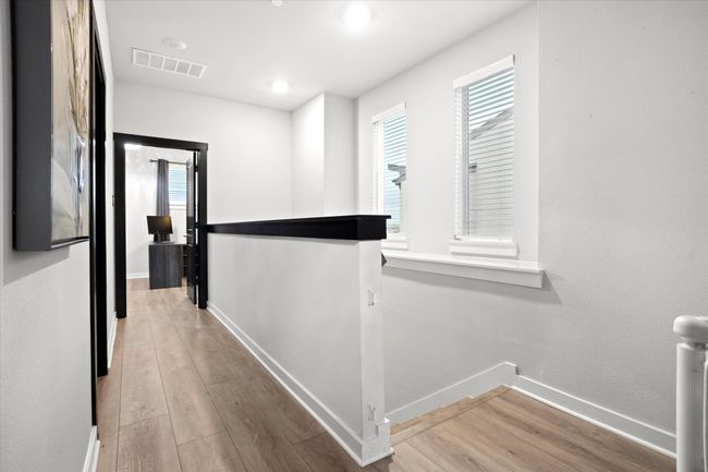 Corridor with an upstairs landing and light wood finished floors | Image 12