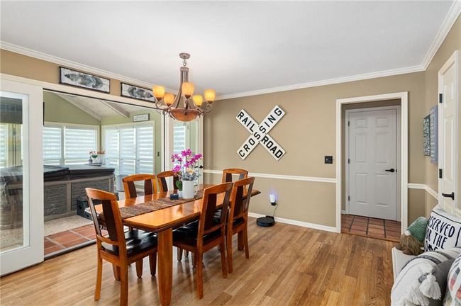 Dining space featuring ornamental molding, a chandelier, and light wood-type flooring | Image 16