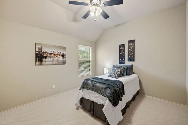 Bedroom with carpet flooring, vaulted ceiling, and ceiling fan | Image 22