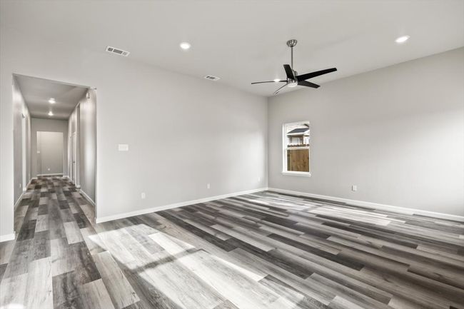 Family room featuring ceiling fan and dark hardwood / wood-style floors | Image 4