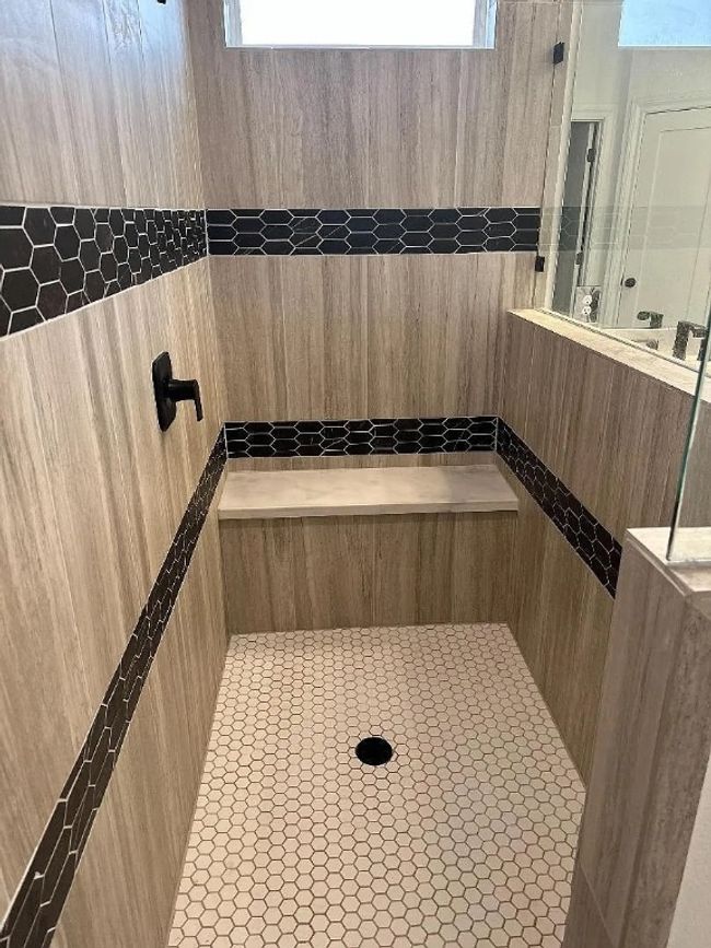 Full bathroom featuring a tile shower and plenty of natural light | Image 7