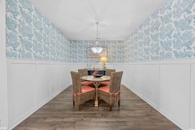 Dining room with a wainscoted wall, wallpapered walls, and wood finished floors | Image 12