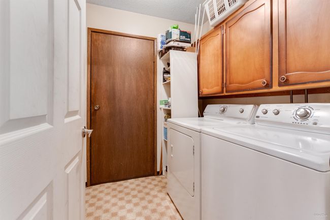 Laundry area featuring washer and dryer, cabinet space, and light floors | Image 15