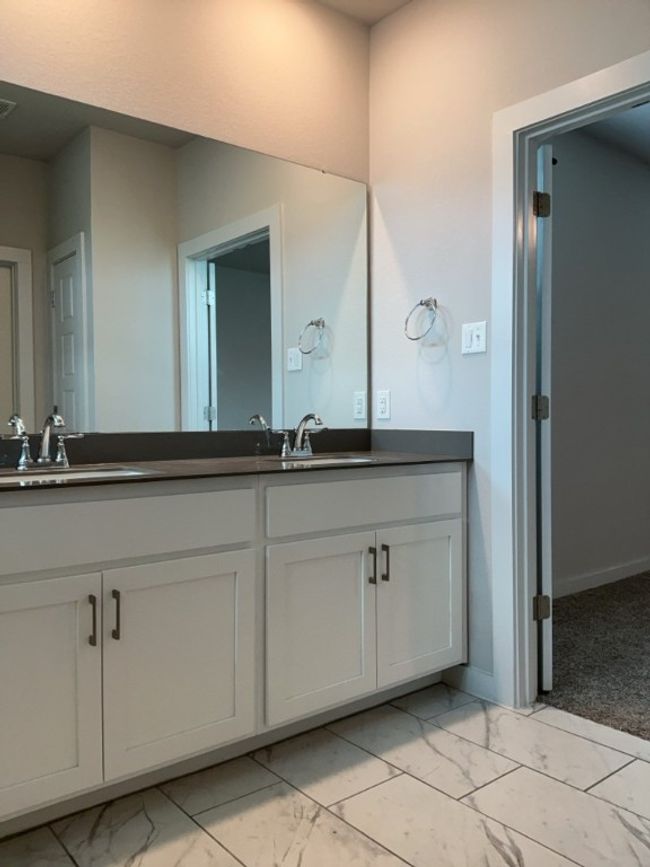Full bathroom featuring marble look tiles and double vanity | Image 18