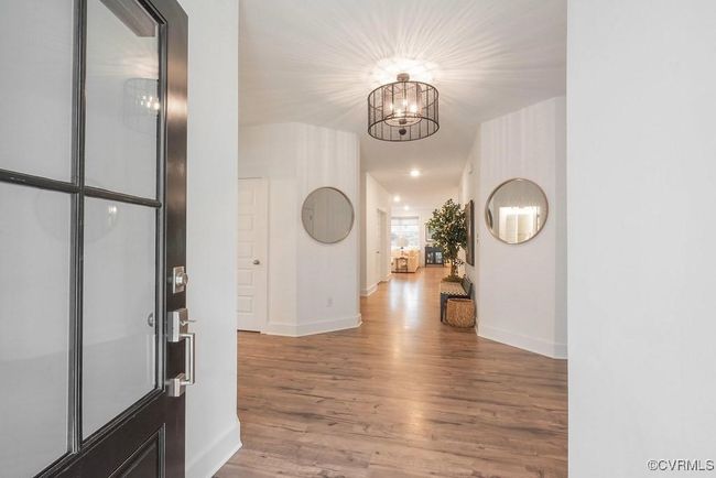 Entryway with a chandelier and wood finished floors | Image 5
