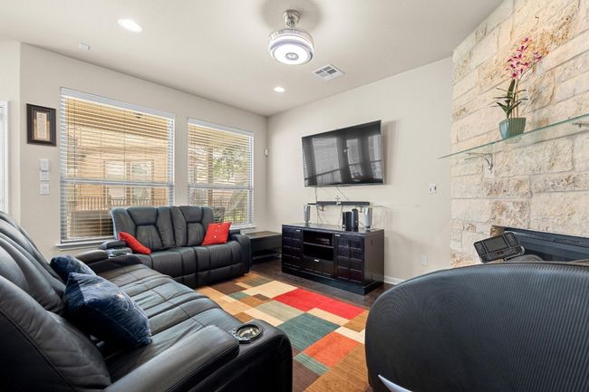 Windows along the living room wall provide peaceful backyard views and infuse the main living area is peaceful morning sunlight. | Image 10