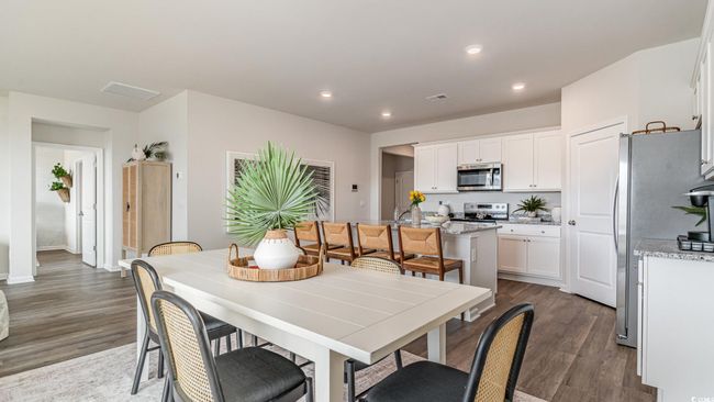 Dining space featuring dark wood-style flooring, recessed lighting, and baseboards | Image 8