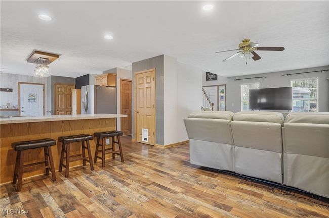 Living room featuring ceiling fan, light wood-type flooring, recessed lighting, and baseboards | Image 10