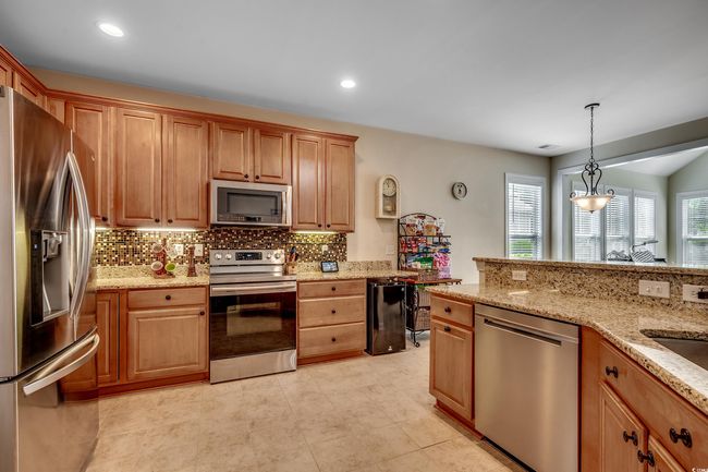 Granite counters, stainless appliances and mini fridge | Image 8