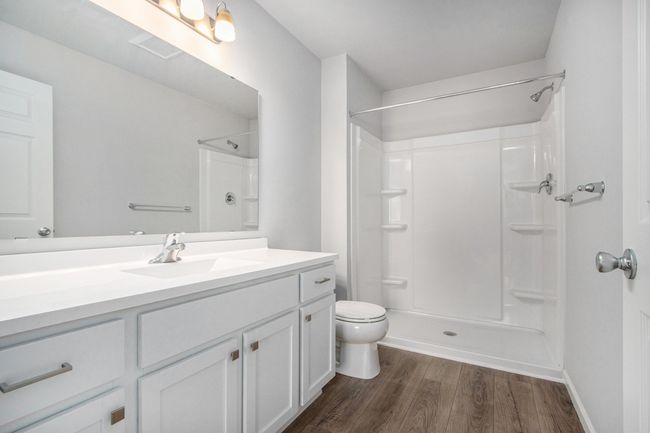 The luxurious primary suite includes a private bath and large walk-in closet. | Image 13