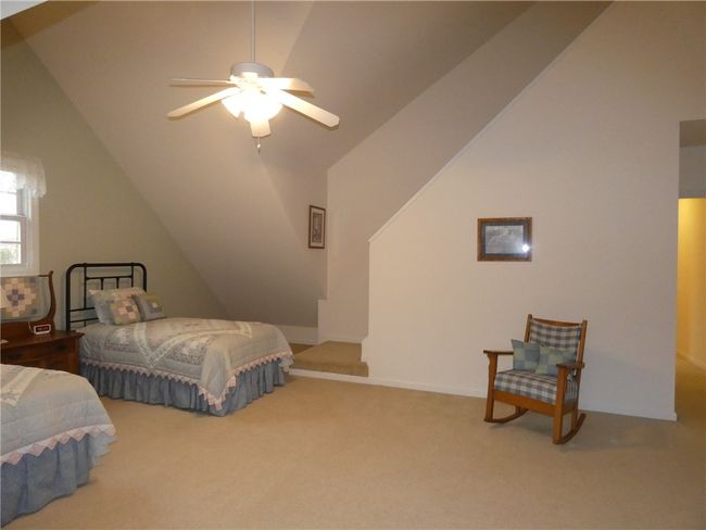 Located on the upper level is bedroom 2, the largest of the guest bedrooms | Image 32