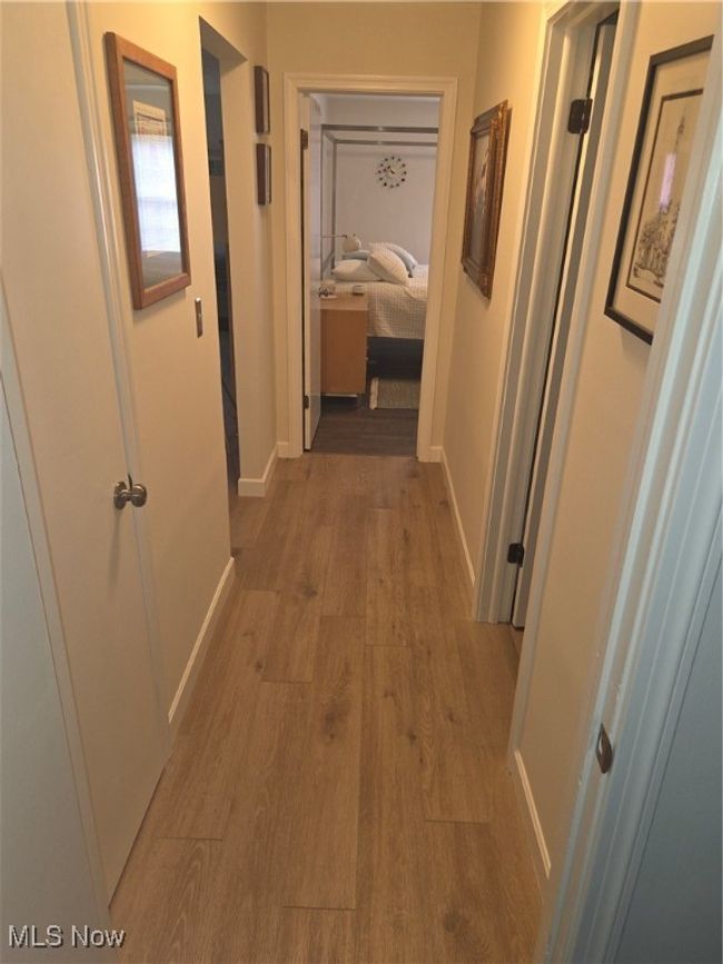 Hallway featuring wood finished floors and baseboards | Image 21