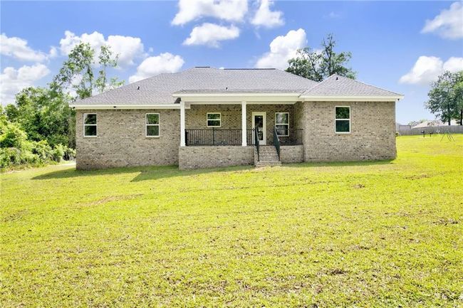 Rear view of property with brick siding, a yard, and a porch | Image 31