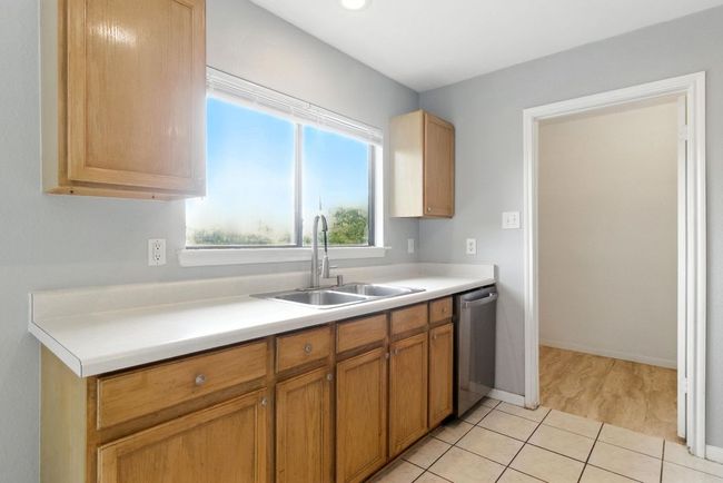 Good amount of cabinets and drawers. Cased opening is for the pantry/laundry room. | Image 9