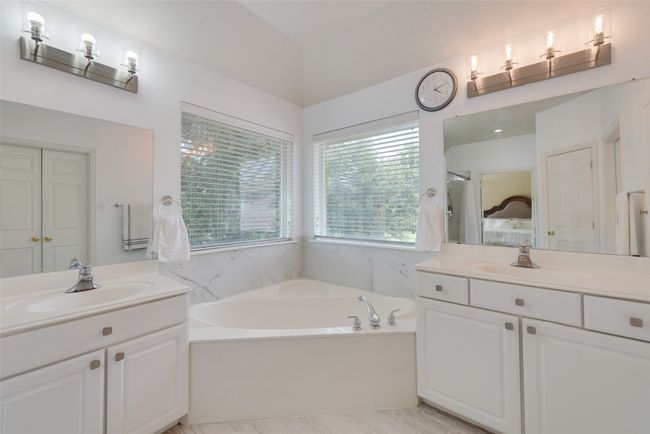 Full bath featuring a garden tub, two vanities, and a sink | Image 20