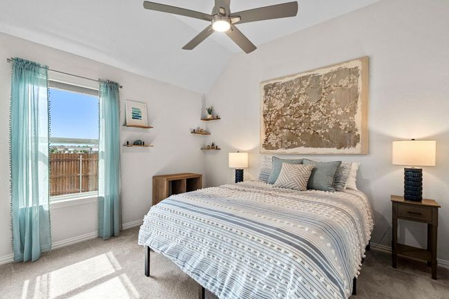 Secondary bedroom with neutral colors and ceiling fan. | Image 12