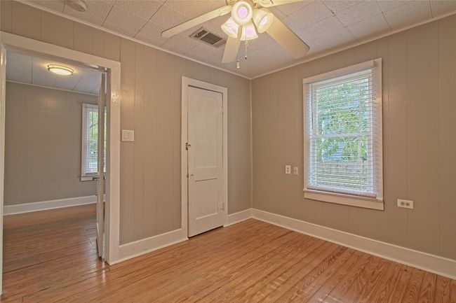 Unfurnished room featuring light wood-type flooring, ornamental molding, and ceiling fan | Image 21