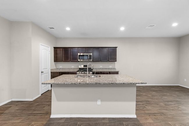 A closer view of the large island, complete with stainless steel sink. | Image 17