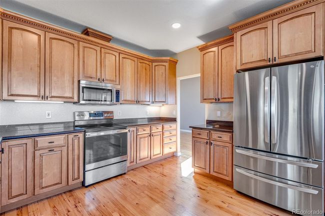 Kitchen with appliances with stainless steel finishes, recessed lighting, and light wood finished floors | Image 12
