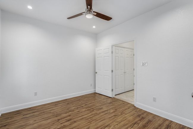 Empty room with baseboards, a ceiling fan, recessed lighting, and wood finished floors | Image 11