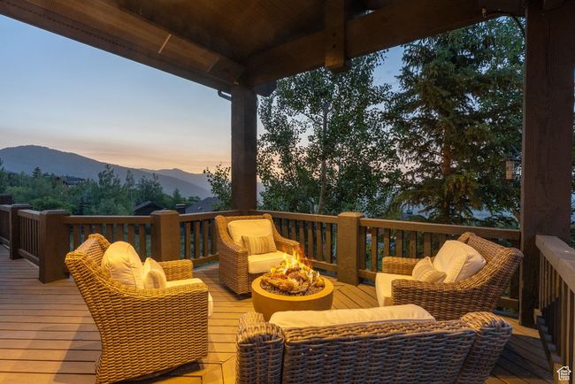 Deck at dusk with an outdoor fire pit and a mountain view | Image 34