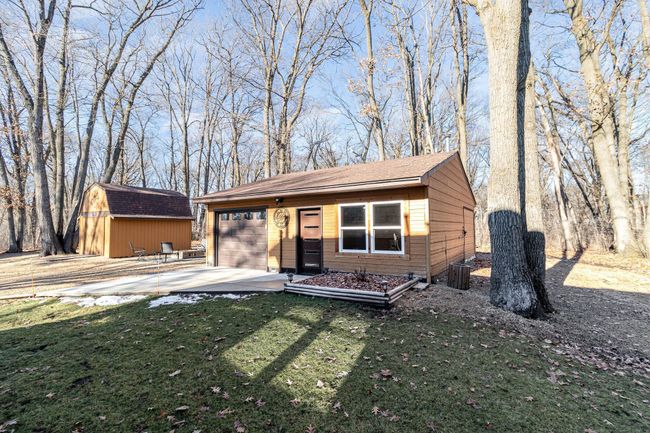 The DREAM workshop garage has so many uses. It features: 7-ft garage door w/opener, generous rafter storage w/pull down ladder, 100 amp service, loads of outlets, long workbench, cabinets, newer windows, painted cement floor, ceiling fan & much more. | Image 7