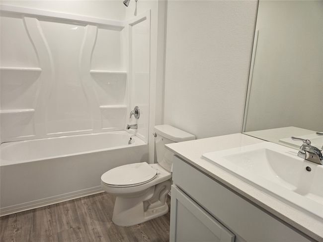 Full bathroom featuring vanity, bathing tub / shower combination, toilet, and wood finished floors | Image 14