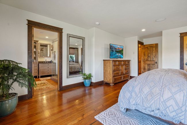 Bedroom featuring wood finished floors, a sink, baseboards, and recessed lighting | Image 39