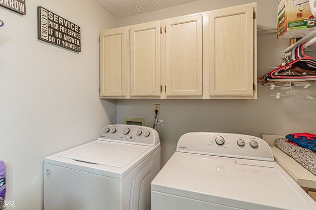 washroom featuring independent washer and dryer and cabinet space | Image 23