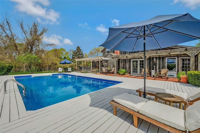 Swimming pool featuring a deck, a pergola, and french doors | Image 16