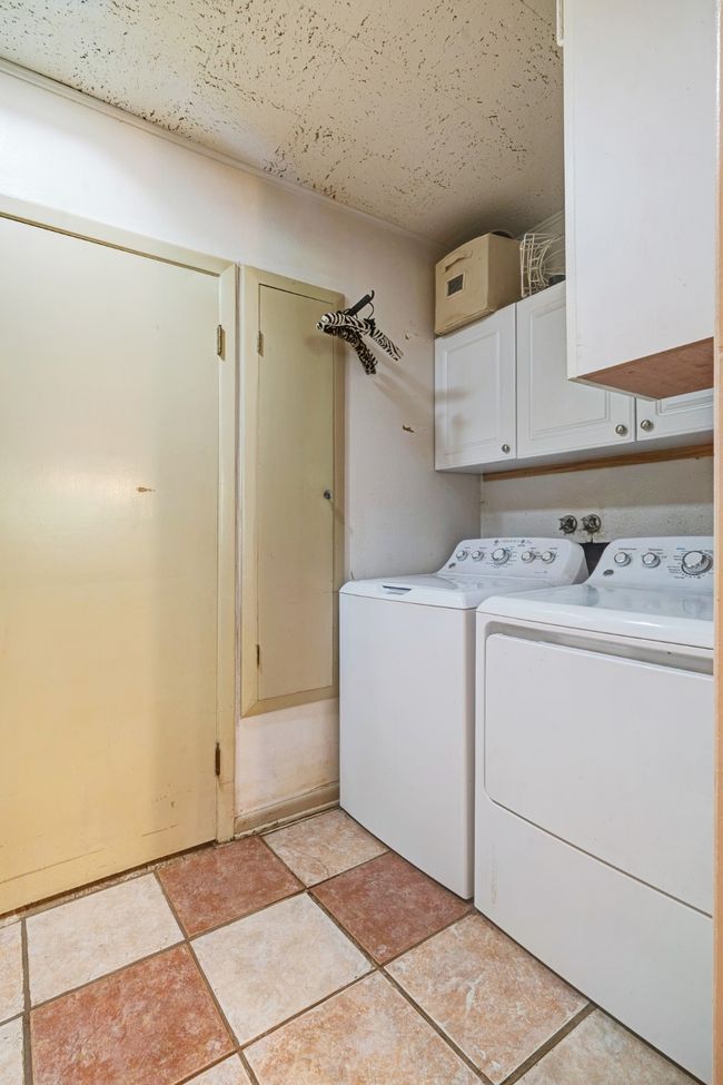 Laundry area featuring cabinet space and separate washer and dryer | Image 6