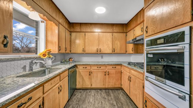 Kitchen with great storage, new stainless steel appliances and tile backsplash behind cooktop | Image 14
