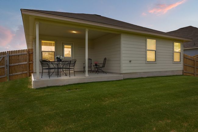 Back of house at dusk featuring a fenced backyard and a patio area | Image 38