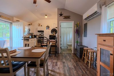 Dining space featuring ceiling fan, plenty of natural light, and vaulted ceiling | Image 2