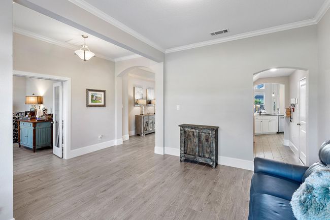 Elegant and inviting, this family space shines with bright, neutral tones and a seamless flow into the kitchen and living areas—making it the ultimate setting for both everyday living and effortless entertaining. | Image 8