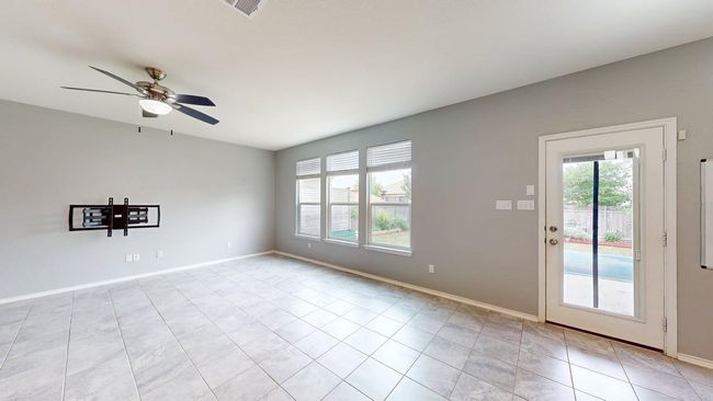 Empty room with baseboards, ceiling fan, light tile patterned floors, and visible vents | Image 20