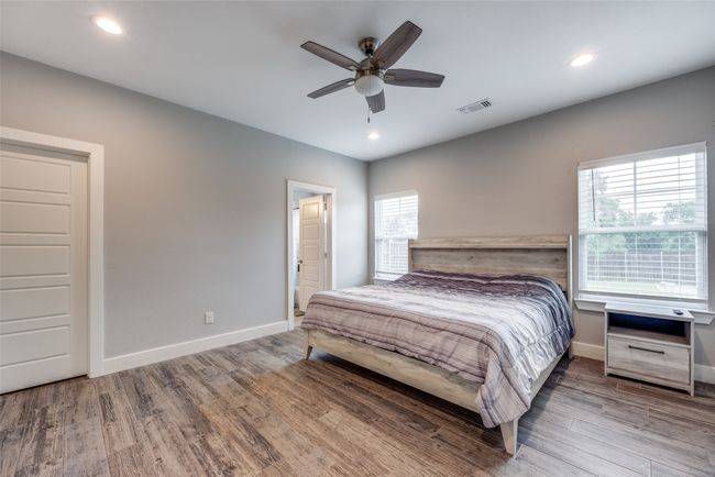 Bedroom with wood finished floors, baseboards, recessed lighting, and ceiling fan | Image 6