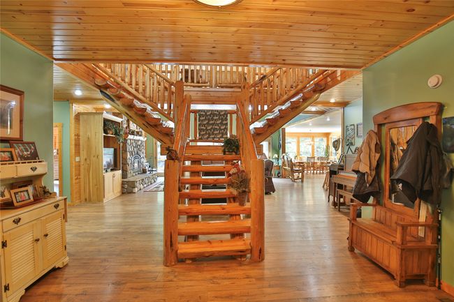 Stairway featuring hardwood / wood-style floors and wooden ceiling | Image 19