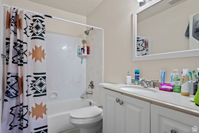 Full bathroom with vanity and shower / bath combination with curtain | Image 31