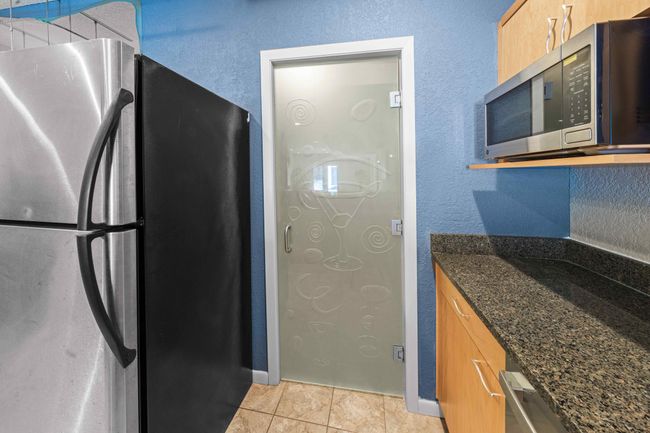 Glass door to storage/wine room | Image 33