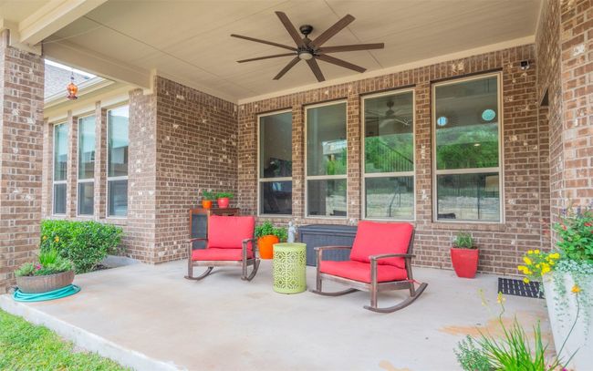 The large covered patio overlooks the serene backyard of the home. Enjoy this relaxing atmosphere. The possibilities for this space are abundant! | Image 27