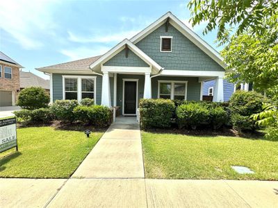 View of front of house featuring a garage and a front yard | Image 1