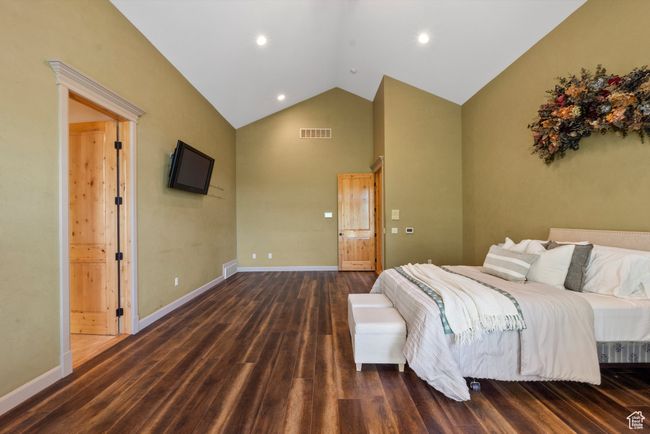 Master Bedroom with high vaulted ceiling, wood finished floors, baseboards, and recessed lighting | Image 37