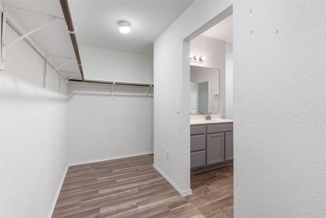 Walk in closet with wood finished floors | Image 15